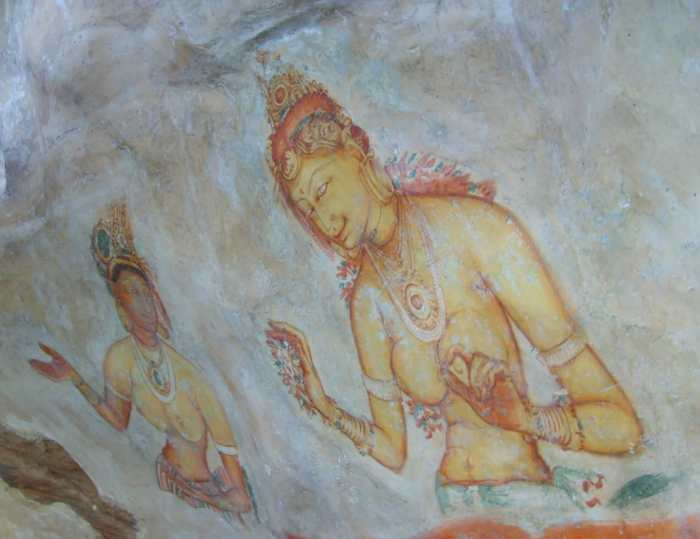 The painted figures in a sheltered pocket of the rock face.